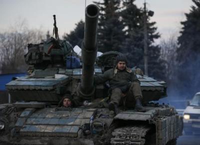 Ukrainian servicemen ride on a tank near Artemivsk