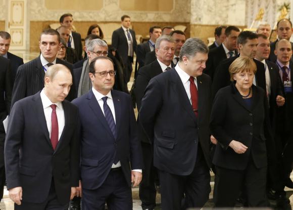 Russia's President Putin, Ukraine's President Poroshenko, Germany's Chancellor Merkel and France's President Hollande walk during peace talks in Minsk